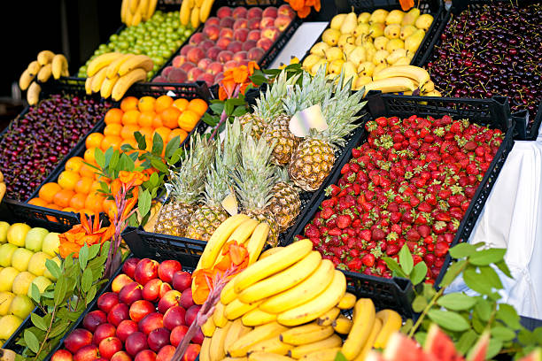 fruits and berries on display at the market stock photo