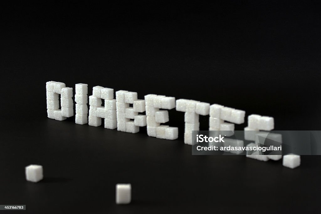 written diabetes written diabetes with cubic sugar on a black background. Alphabet Stock Photo