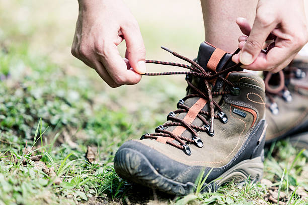 istock Female hiker tying boot laces 453167865