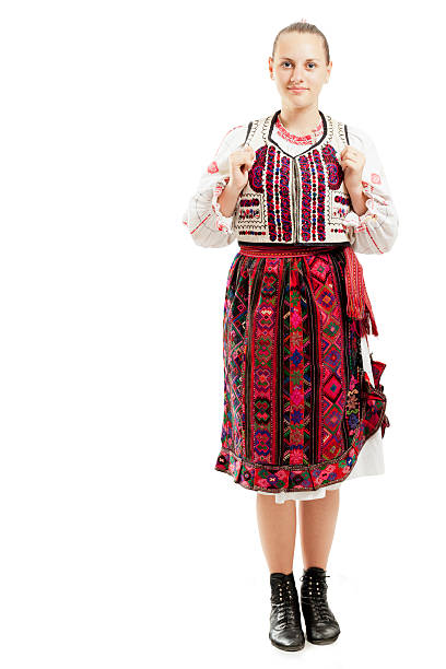 A beautiful young woman in a traditional costume from Bulgaria. On a white background.