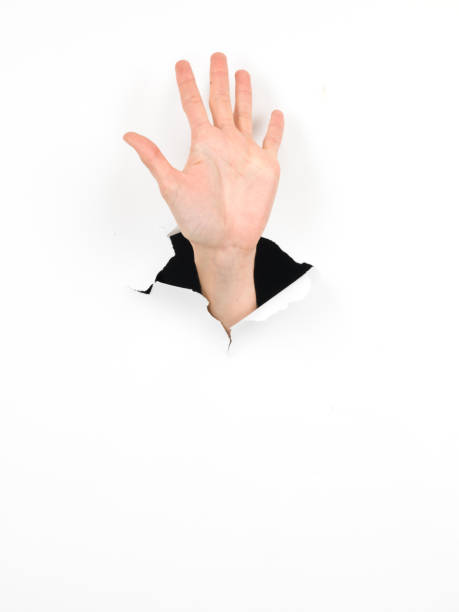 istock female hand, high five gesture, paper with hole 453172267
