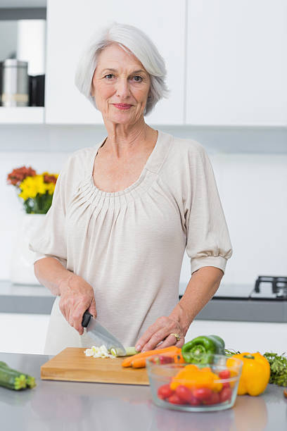 istock Cheerful mature woman preparing vegetables 453173549