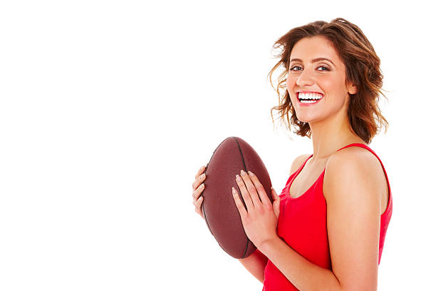 istock Cheerful young female with football 453173961