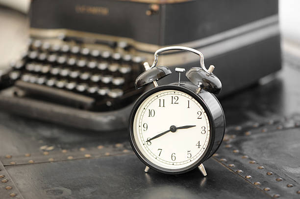 Clock and typewriter stock photo