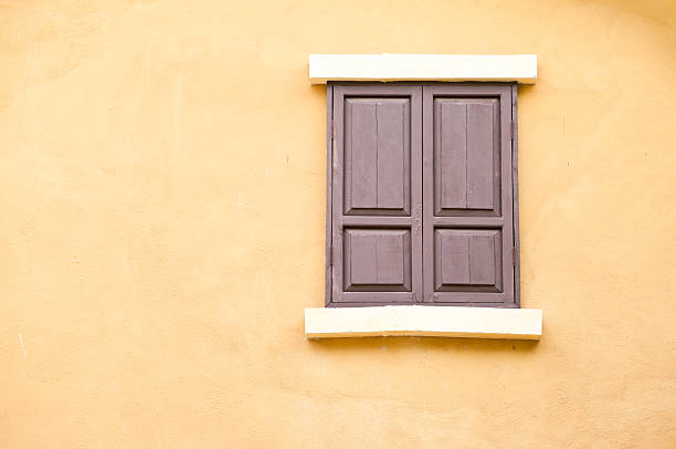 istock old wood windows on the yellow wall 453175233