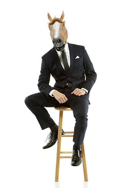 uomo d'affari con cavallo di testa seduto su uno sgabello - horse men animal head bizarre foto e immagini stock
