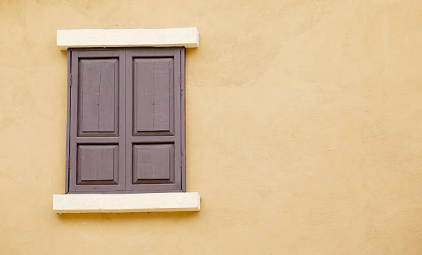 istock old wood windows on the yellow wall 453175807