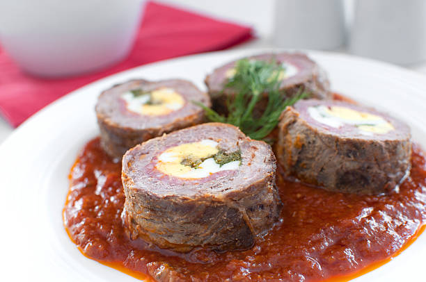 Roulade with meat and eggs in tomato sauce