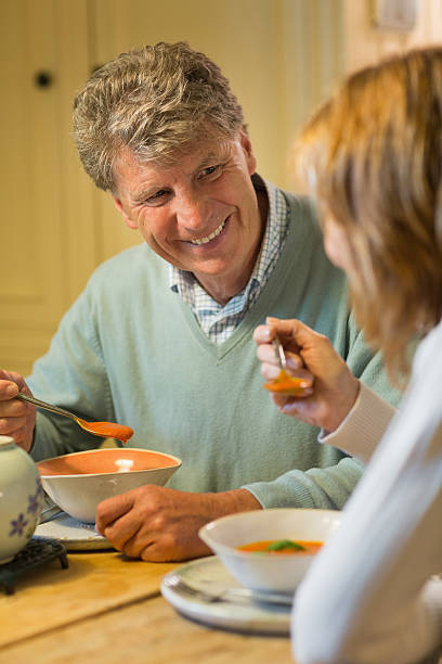 istock Pleased mature couple eating soup 453181825