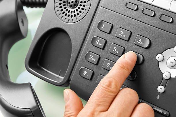 istock Finger dialing number on a modern office telephone 453182153