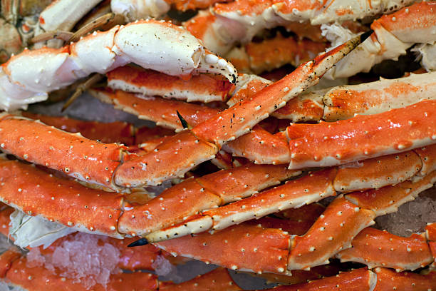 Alaskan King Crab legs on ice in market.  Close-up. stock photo
