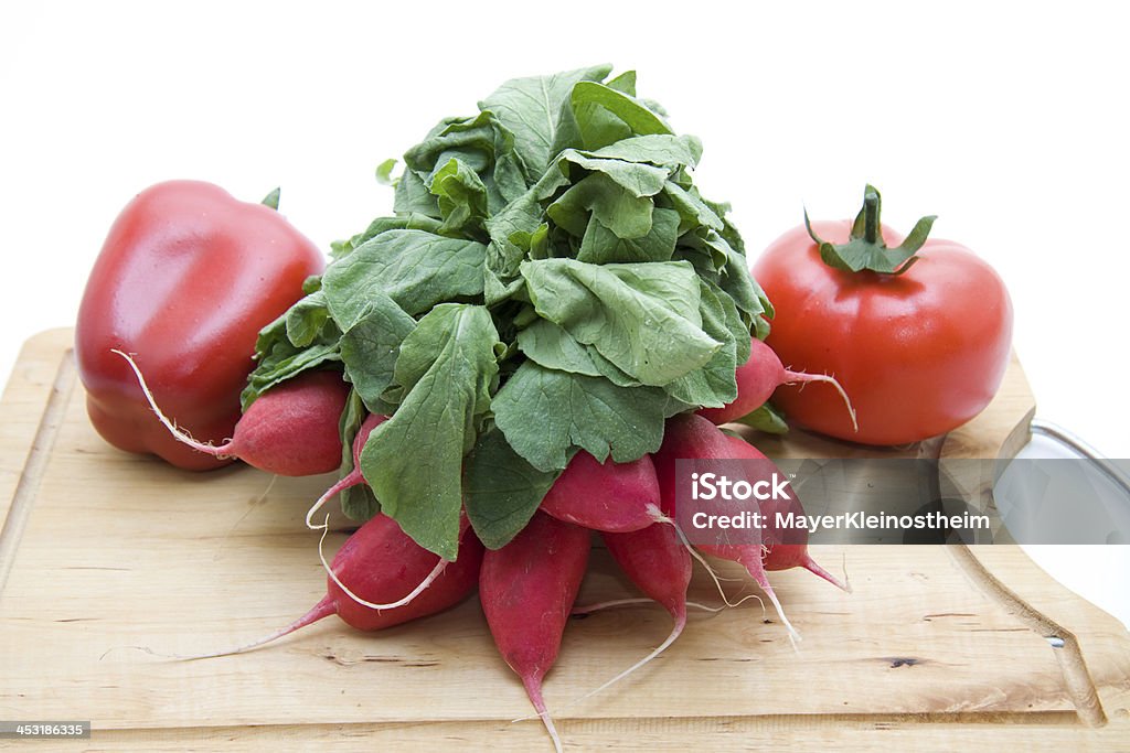 Radishes and tomatoes with paprika Radishes and tomatoes with paprika on edge board Bell Pepper Stock Photo