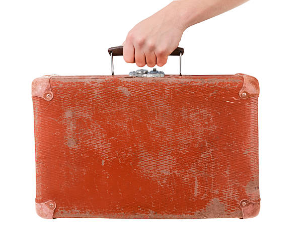 Vintage red suitcase in male hand