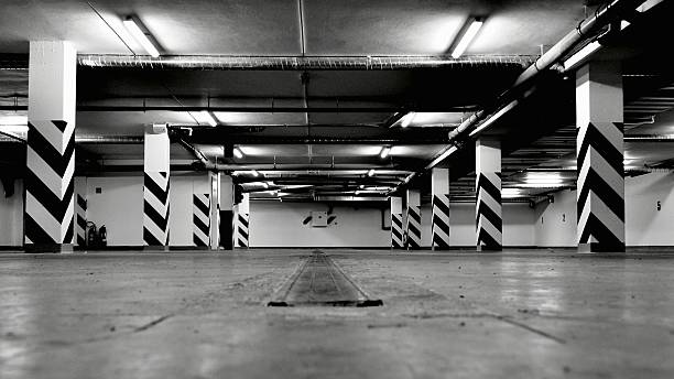 istock Black and white photo of empty underground parking garage 453187369