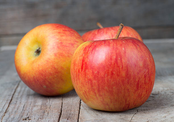 istock Red apple fruit ripe dew on wood background 453188391