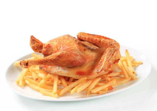 Close up whole chicken and fries dish