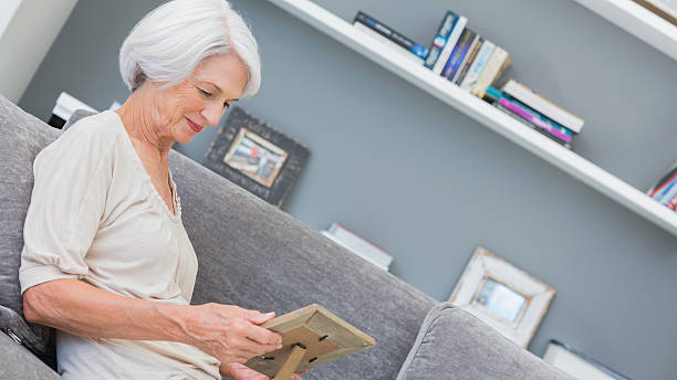 istock Mature woman looking at photo in a frame 453194105