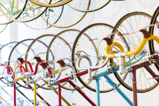 Retro racing bicycles hanging in bike shop.