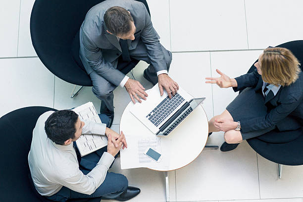 istock Three people meeting on small table in lobby 453194703