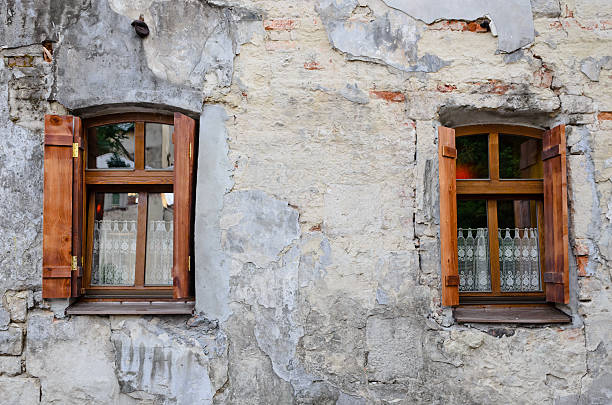 istock Two wooden windows on an old degraded wall 453195751
