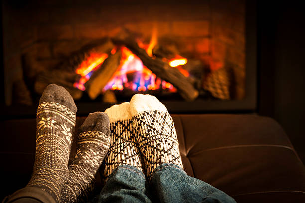 Feet warming by fireplace Feet in wool socks warming by cozy fire wool photos stock pictures, royalty-free photos & images