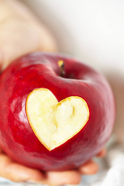 istock red apple with a heart shaped cut-out 453199131