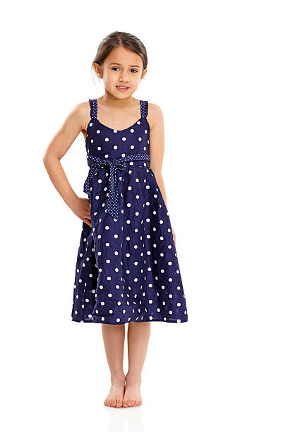 милая маленькая девочка, которые позируют в красивом синем платье на белом - little girls pre adolescent child standing isolated стоковые фото и изображения