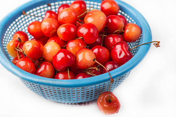 istock fresh cherry with drop the water in blue colander 453203293