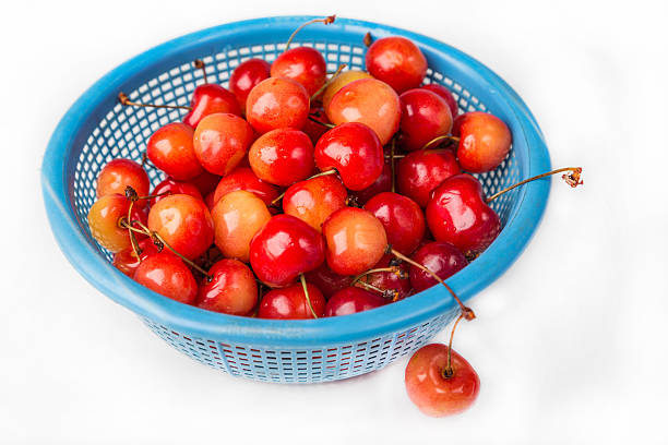 istock fresh cherry with drop the water in blue colander 453203299