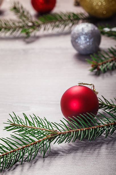 istock Baubles and pine branches scattered over wooden plank 453204143