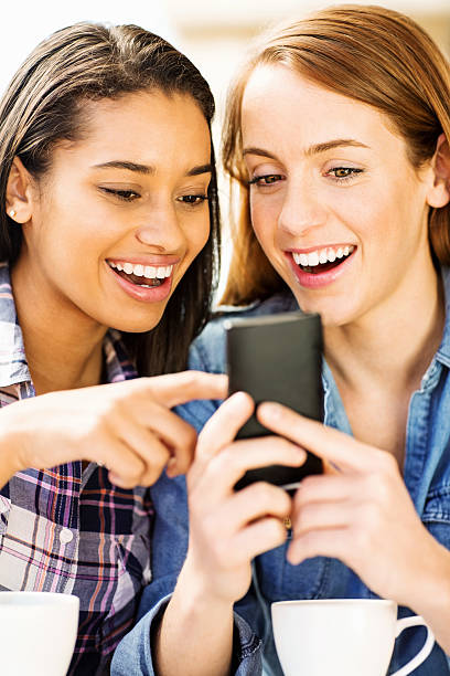 istock Teenage Friends Using Smart Phone While Having Coffee At Cafe 453205773