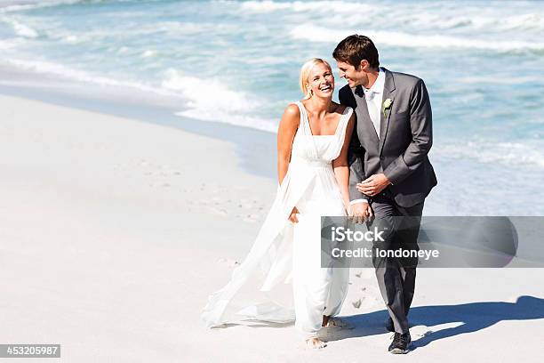 Bride And Groom Walking On Beach Stock Photo - Download Image Now - Beach, Wedding, Groom - Human Role