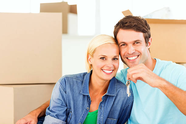 istock Young Couple Holding Up New House Keys 453206005