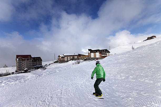 skiers skiing on the ski slope. skiers climbing hill with lift