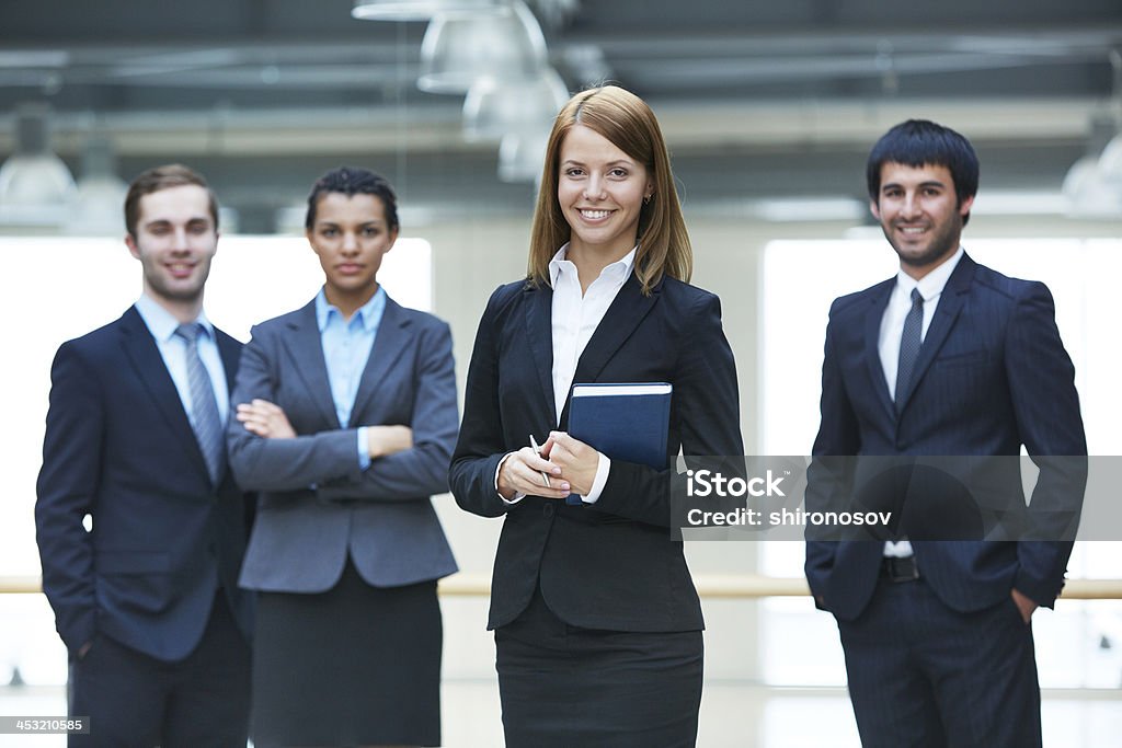 Female leader Group of smart businesspeople with happy female leader in front Adult Stock Photo