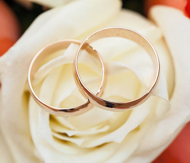 istock wedding rings  groom and bride on a bunch of flow 453218007