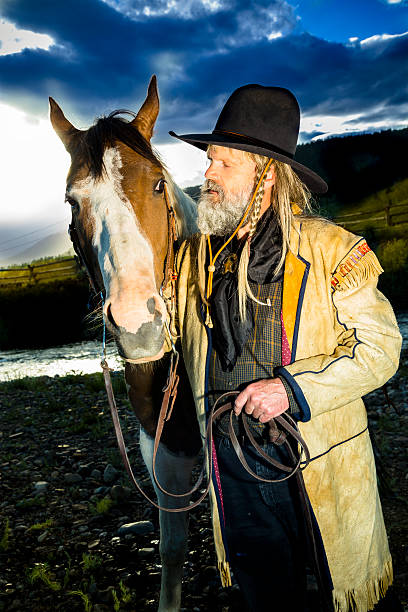 istock Character: 1800's period dressed man travels through Rocky Mountains. 453220545