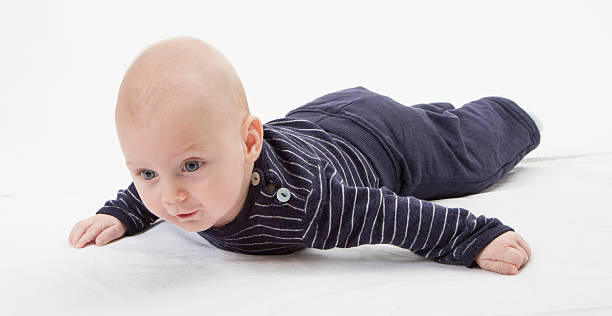 cheerful baby trying to get around stock photo