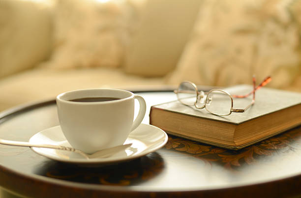 istock Coffee and book by bedside with reading glasses 453226253