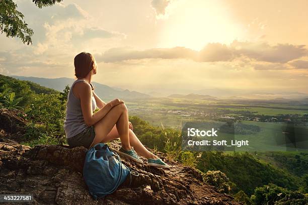 Girl Sits On Edge Cliff And Looking At Sun Valley Stock Photo - Download Image Now - Women, Nature, Mountain