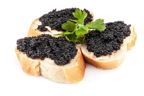 istock Sandwiches with black caviar isolated on white background 453228995