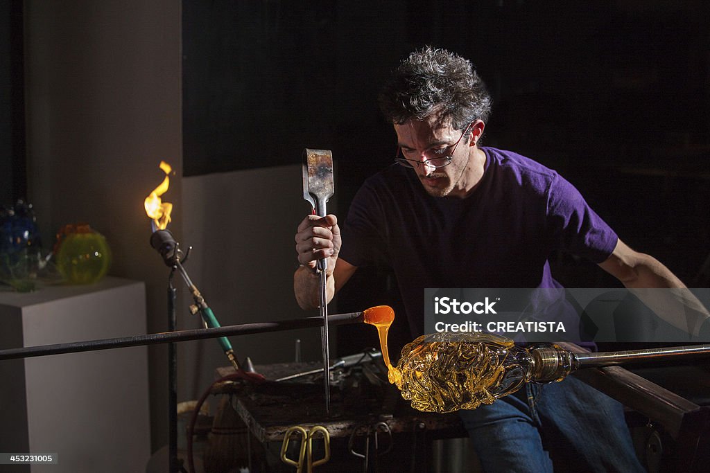 Man Decorating Glass Jar Worker using pliers and rod to decorate glass object Adult Stock Photo