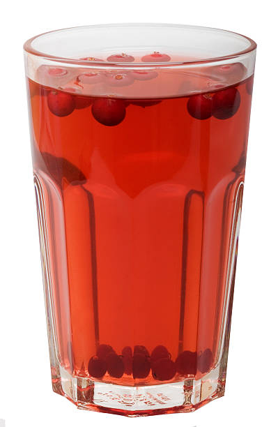 Red cranberry fruit drink in the glass One red cranberry fruit drink in the glass. marshwort stock pictures, royalty-free photos & images