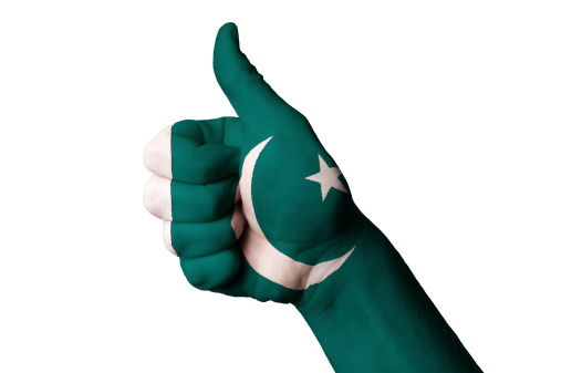 Hand with thumb up gesture in colored pakistan national flag as symbol of excellence, achievement, good, - for tourism and touristic advertising, positive political, cultural, social management of country