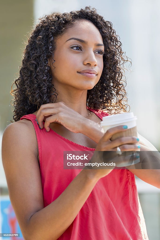 Beautiful Young Woman Beautiful woman with a soft smile and attractive curly hair holding a morning drink. 25-29 Years Stock Photo