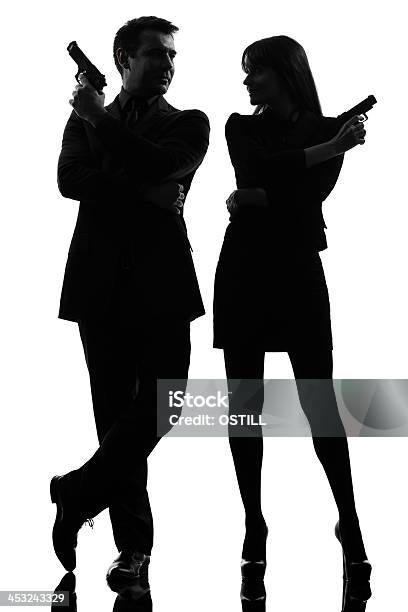 Silhouette Of Detective Couple Holding Guns Stock Photo - Download Image Now - Spy, Secret Service Agent, Detective