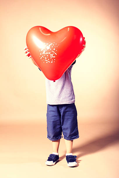 istock Little boy with heart balloon 453246401