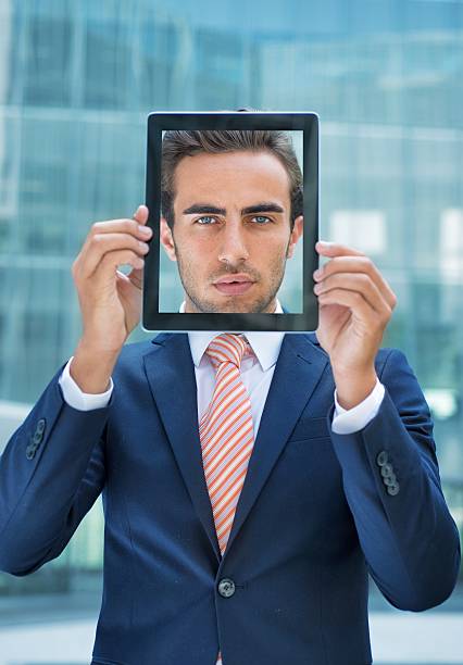 istock Young Businessman With His Face in a Digital Tablet 453248629
