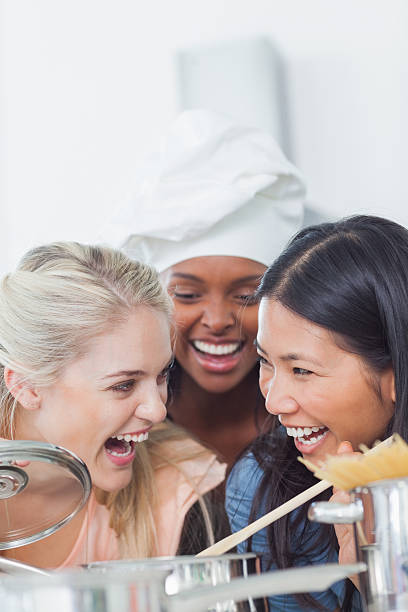 istock Laughing friend smelling the sauce they have made 453249185