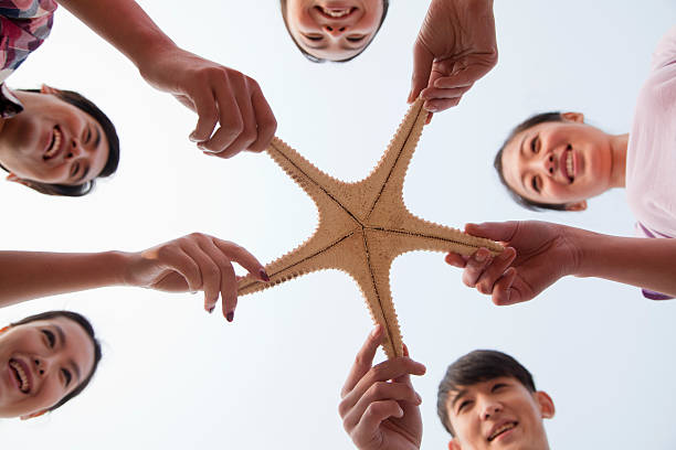 istock Group of Friends Holding a Starfish 453251597